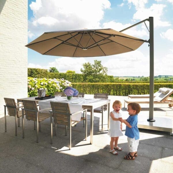 Image of Prostor P7 side post parasol with taupe canopy, with 2 children playing beneath the canopy