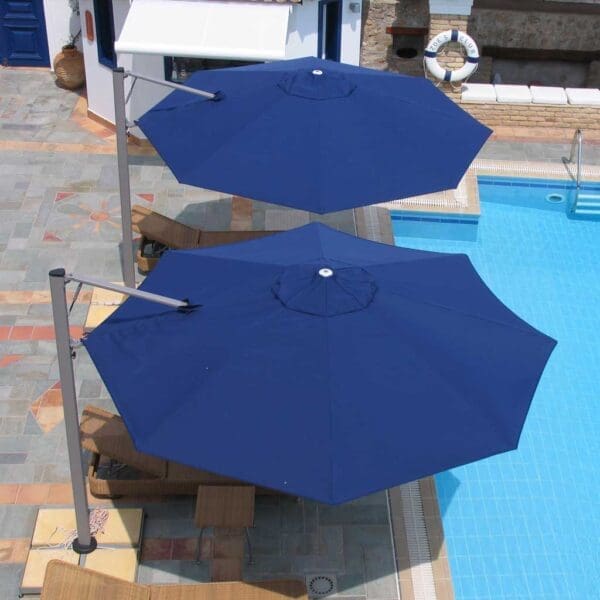 Image of aerial view of 2 Prostor P7 blue octagonal cantilever sunshades on sunny poolside