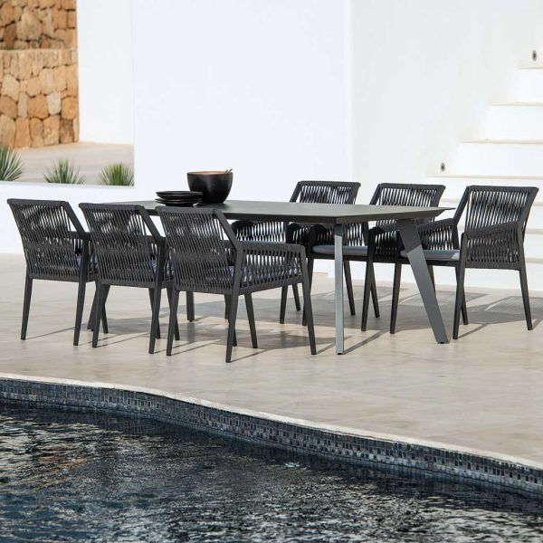 Image of charcoal colored Ritz aluminium outdoor dining furniture by Jati & Kebon on sunny poolside