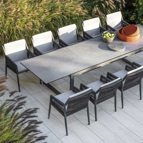 Image of aerial view of Ritz aluminium garden chairs and Vigo XL extendable ceramic garden table on terrace with shrubs in the background