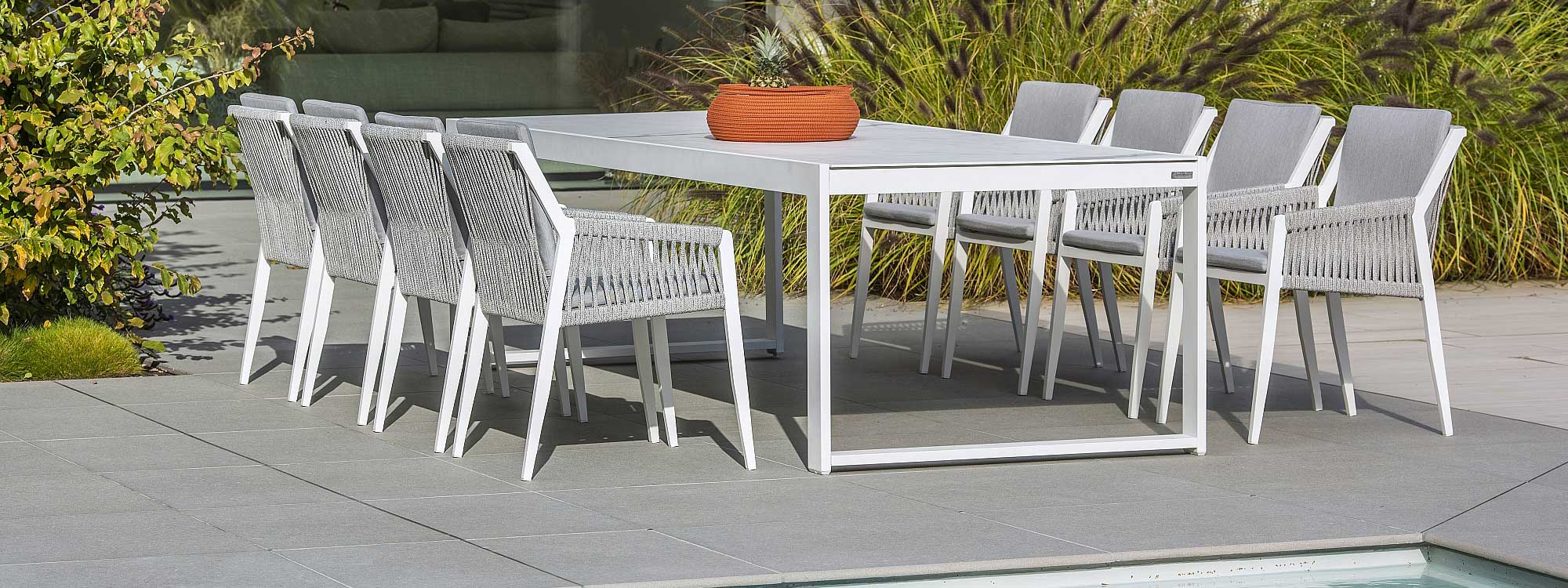 Image of 8 Ritz white garden dining chairs around Vigo XL modern rectangular garden table by Jati & Kebon