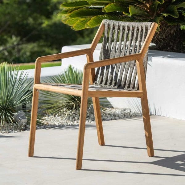 Image of Ritz teak outdoor chair with Taupe colored Polyolefin rope seat and back, shown on sunny terrace