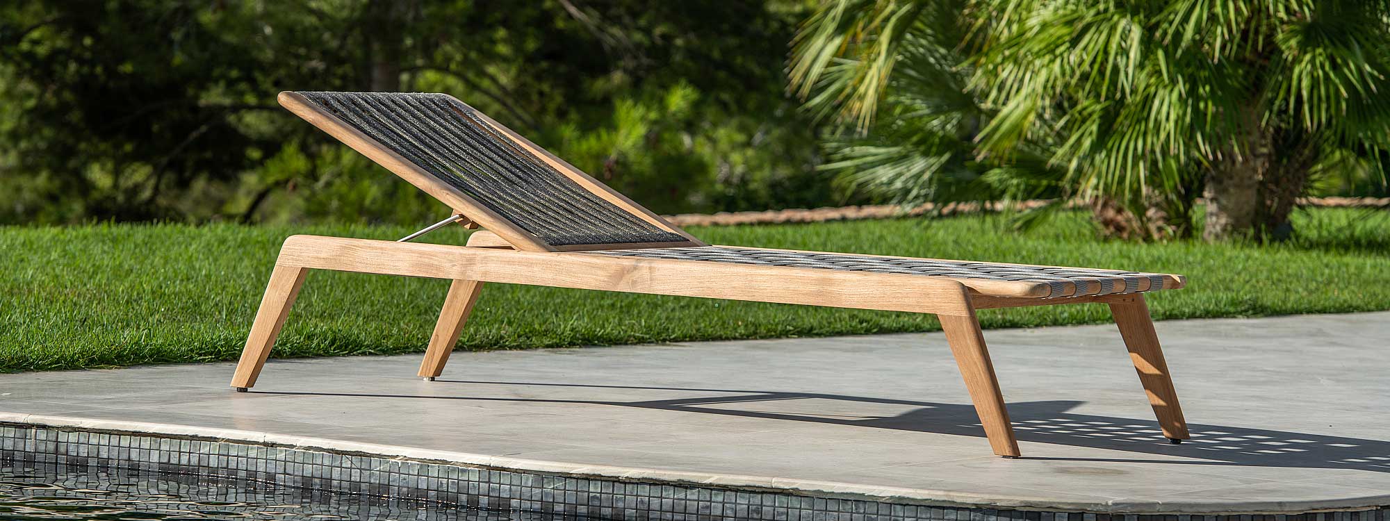 Image of Ritz contemporary teak sun lounger with Polyolefin rope seat and back, shown on sunny poolside
