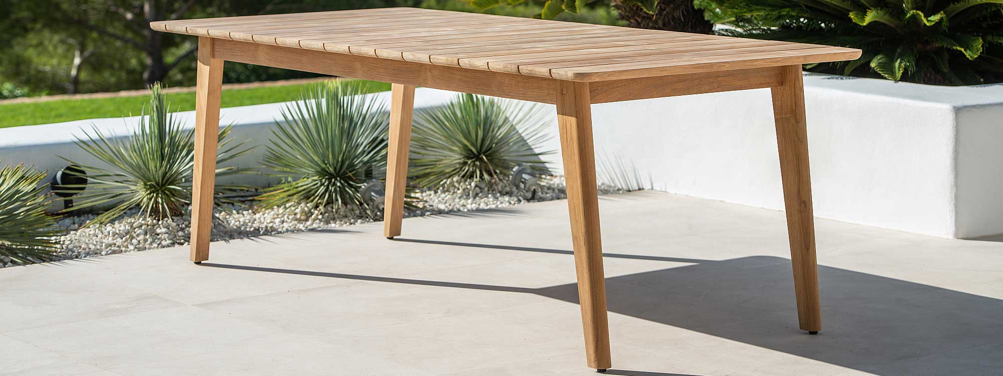 Image of Jati & Kebon Ritz modern garden table in FSC certified teak on sunny terrace