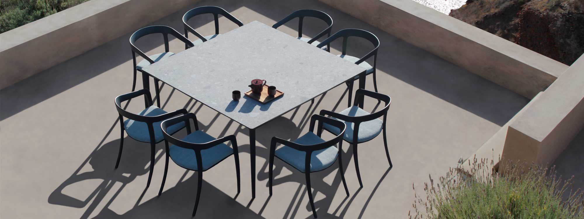 Aerial image of U-nite large square garden table surrounded by 8 Jive chairs by Royal Botania