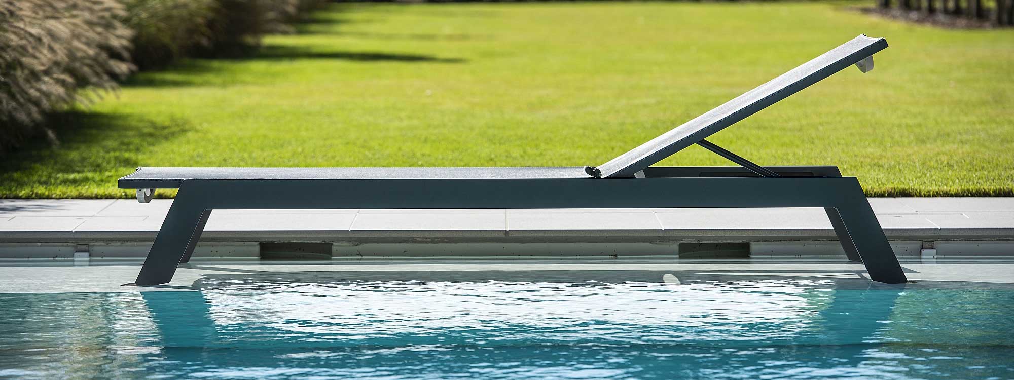 Image of Vigo XL modern sun lounger by Jati & Kebon, placed in shallow water of swimming pool