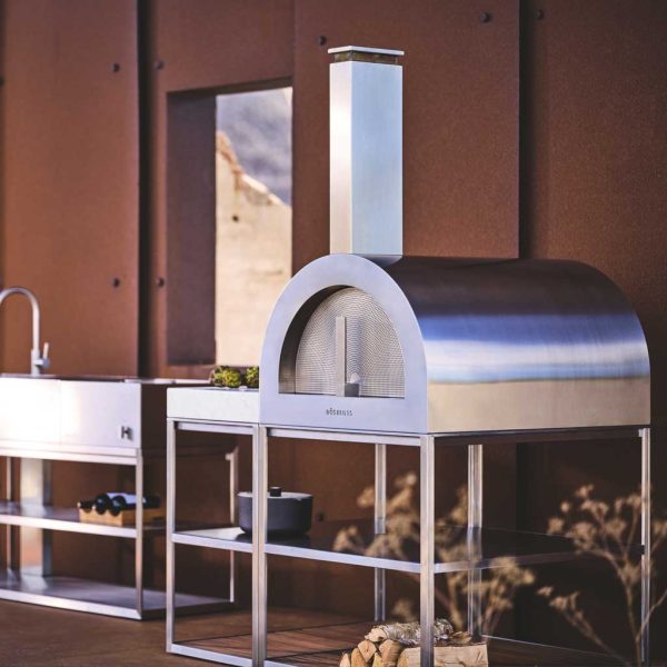 Image of Wood Oven wood-fired pizza oven and Open Kitchen in brushed stainless steel, shown on terrace against oxidised corten steel wall