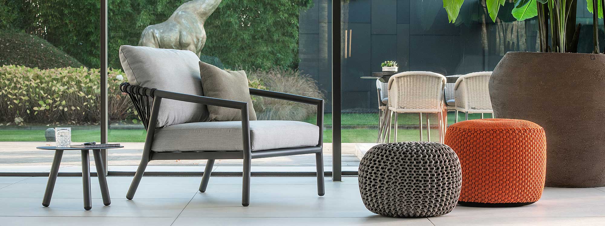 Interior image of Kapra large garden chair with Charcoal tubular aluminium frame and Charcoal Black woven back