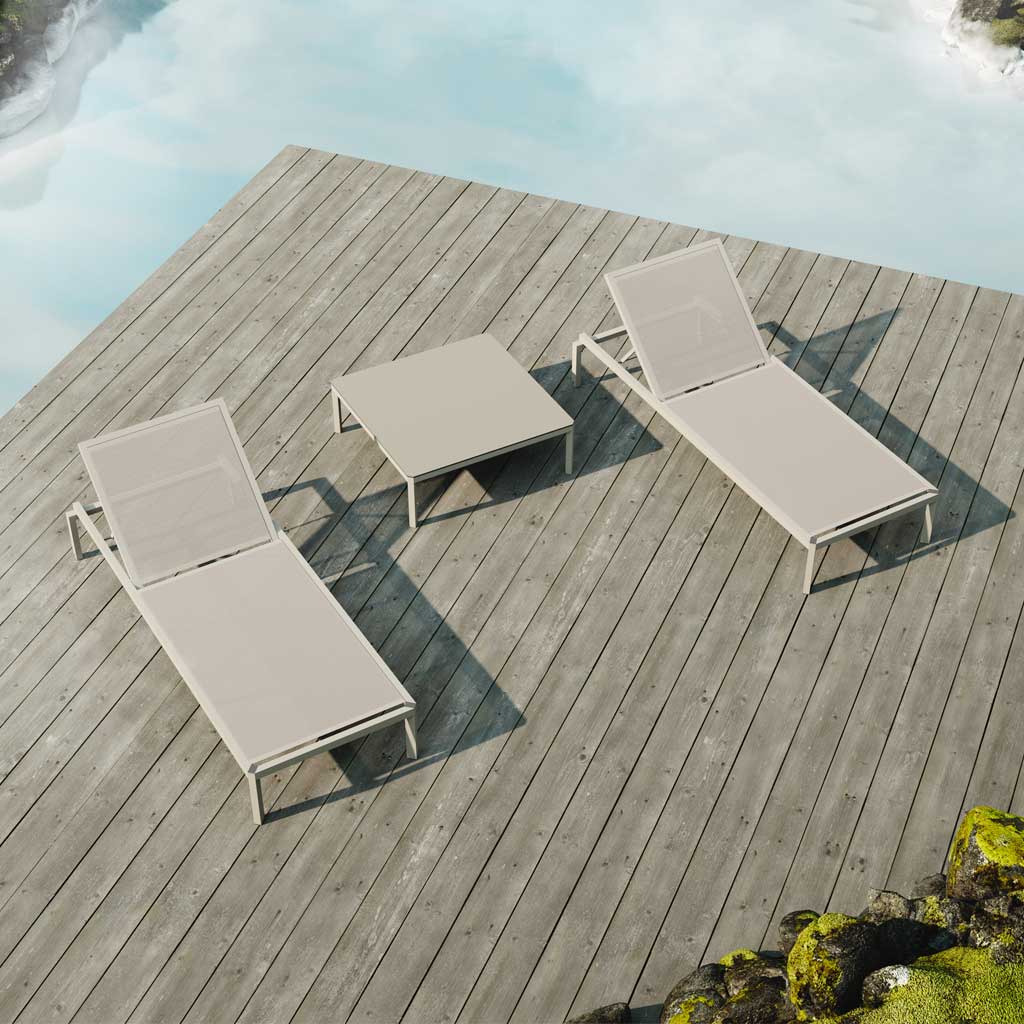 Image of pair of Oiside 45 minimalist sunbeds with small low table in between, shown on wooden decking surrounded with calm water on 2 sides