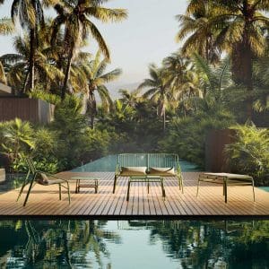 Image of Oiside No 12 green outdoor lounge furniture on wooden decking, surrounded by still waters and exotic planting and palm trees