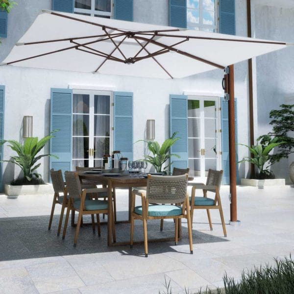 Image of Tuuci Ocean Master cantilever parasol with Aluma-Teak mast and ribs and white Sunbrella canopy, with dining furniture beneath