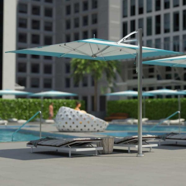 Image of Tuuci side post parasol with turquoise and white canopy and polished aluminum mast and ribs on hotel poolside