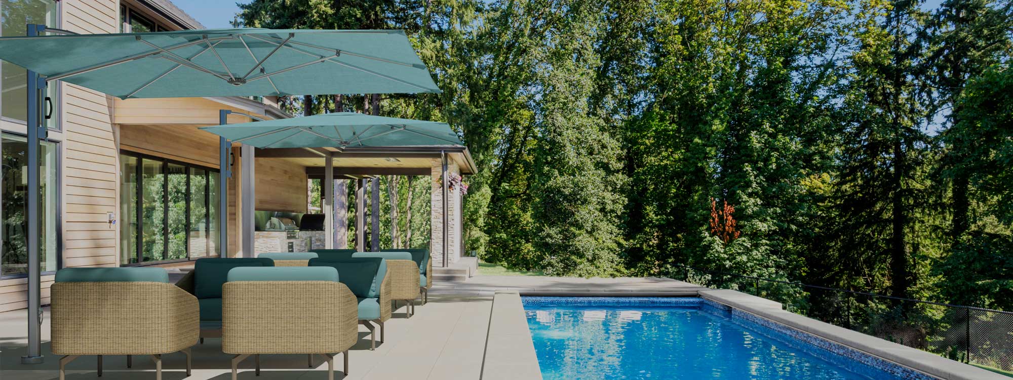 Image of 2 Ocean Master cantilever parasols with green canopies over lounger furniture on terrace, with swimming pool to side, surrounded by woodland