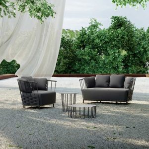Image of Oiside Panama exterior lounge furniture on gravel terrace, with white drape blowing in the wind