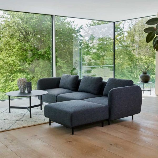 Image of Aura modern 3 seater sofa and ottoman with Dark-Grey Cane-line Ambience fabric upholstery, with Twist circular ceramic coffee table in the centre