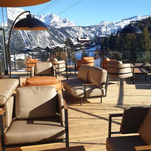 Image of Alpine terrace with Penda luxury outdoor lounge furniture and Heatsail Dome heaters, with snow-capped mountains in the background