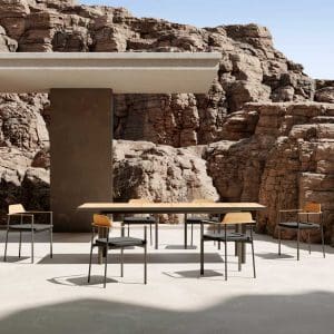 Image of Oiside Penda contemporary outdoor dining set on brutalist terrace, surrounded by arid rockfaces