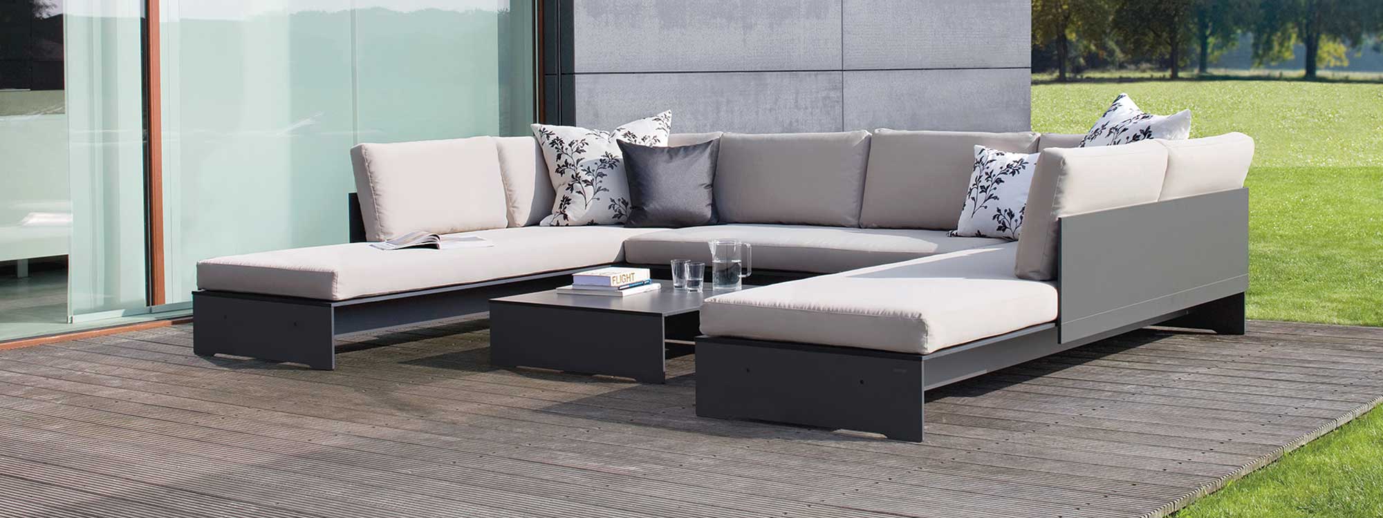 Image of Conmoto Riva low maintenance garden sofa in anthracite coloured HPL and light-grey cushions