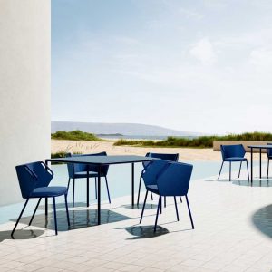 Image of Violet modern garden furniture by Oiside on sunny beachside cafe, with dunes and sea in the background
