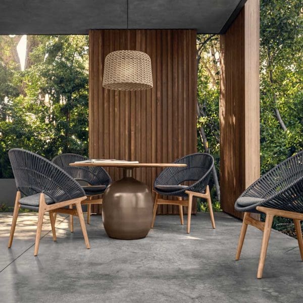 Image of Bora modern teak dining chairs and Gloster Kasha contemporary dining table on shady poured concrete terrace