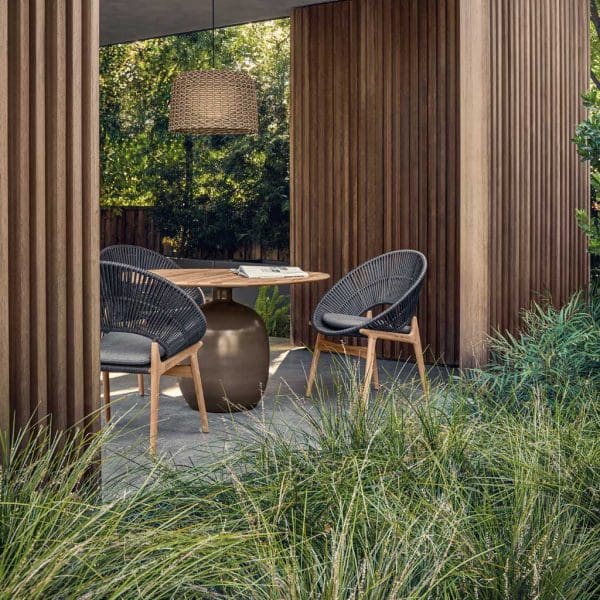 Image of Bora chairs and Kasha table by Gloster inside a modern wooden garden pergola