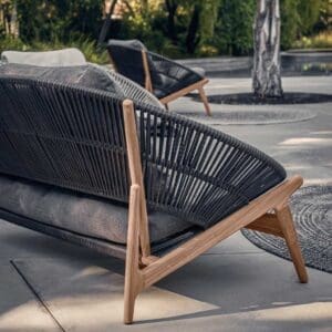 Image of rear view of Gloster Bora modern 2 seat garden sofa in teak and synthetic rattan