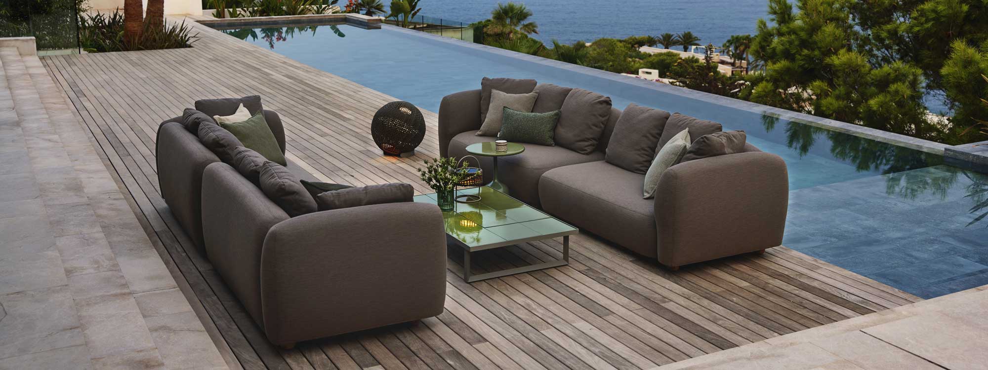 Image of 2 Capture linear garden sofas with Glaze glazed lava stone coffee table by Cane-line in the centre