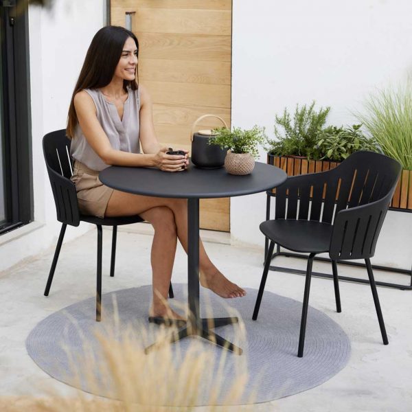 Image of woman sat in Choice sustainable garden chair with recycled polypropylene shell and galvanised steel legs by Cane-line
