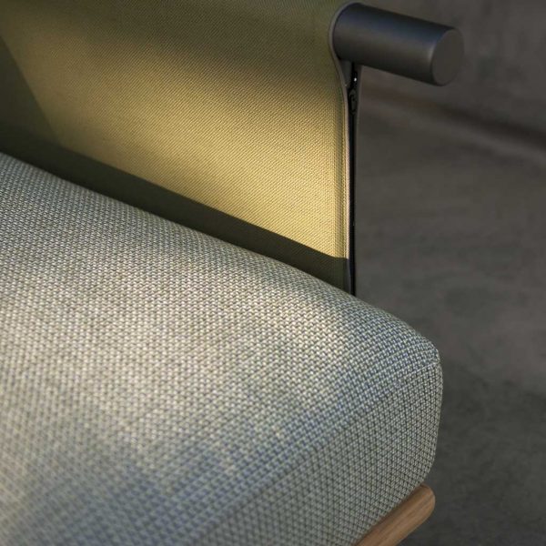 Image in late afternoon sun of detail of Eden garden sofa's upholstery and Batyline fabric arm by RODA
