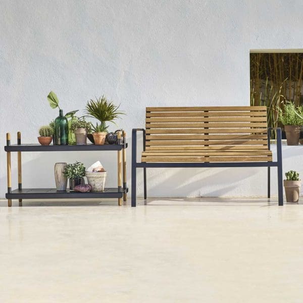 Image of Cane-line Frame garden shelves next to Parc modern outdoor bench on sunny terrace