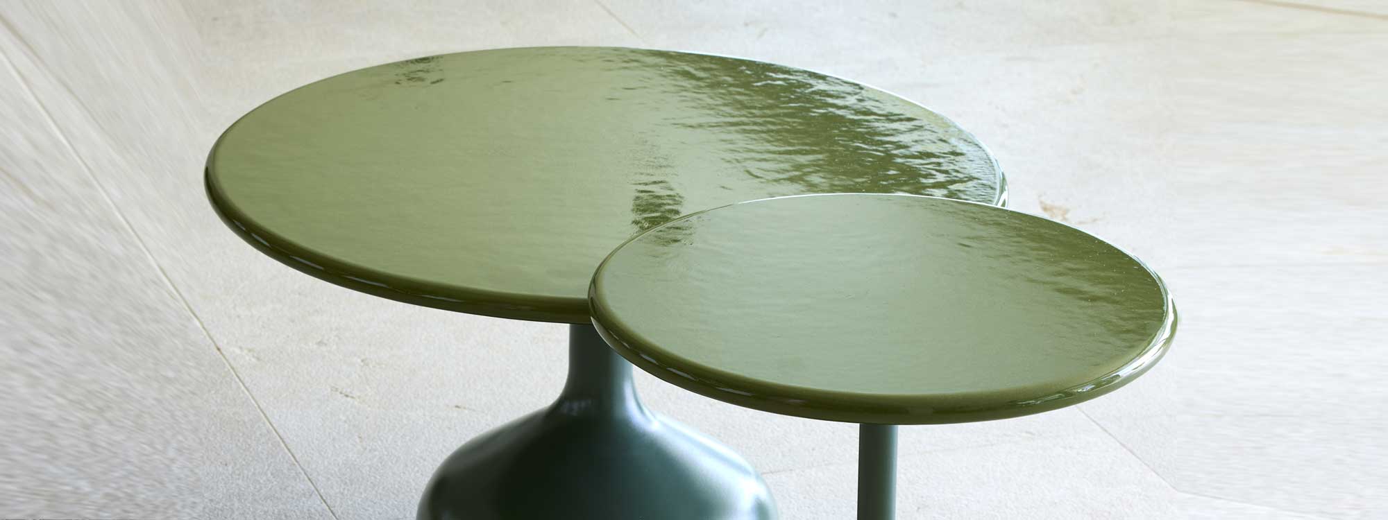 Studio image of Glaze nest of green glazed lava stone low tables by Cane-line