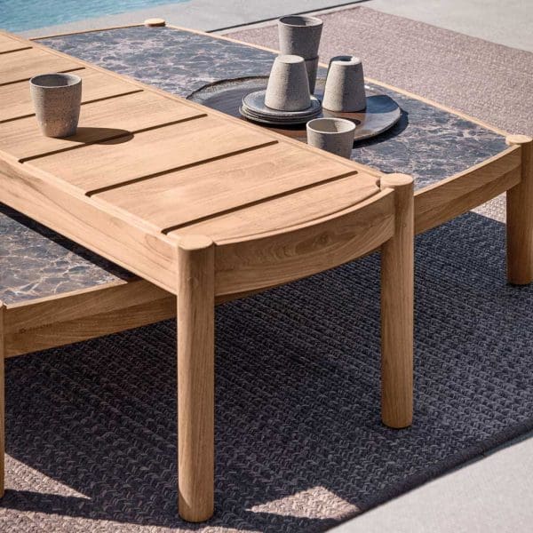 Image of detail of nest of Have teak and ceramic low tables by Gloster