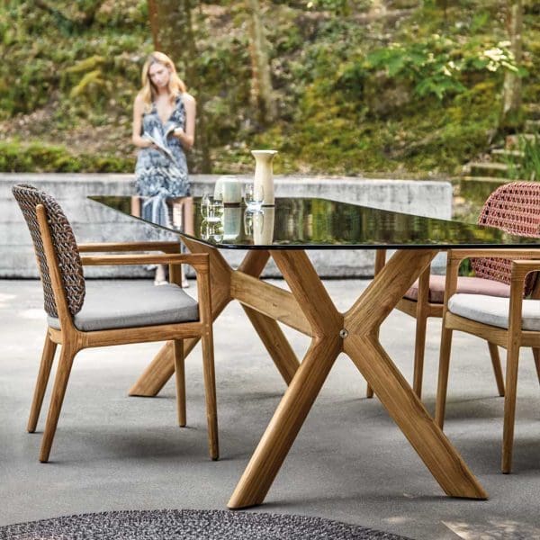 Image of Gloster Kay garden chairs with backs in different colour finishes of all-weather wicker