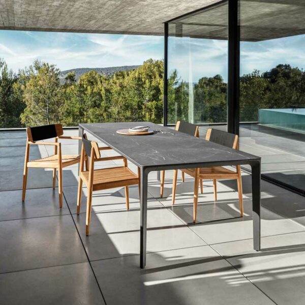 Image of Archi luxury teak armchairs and Carver ceramic garden table by Gloster