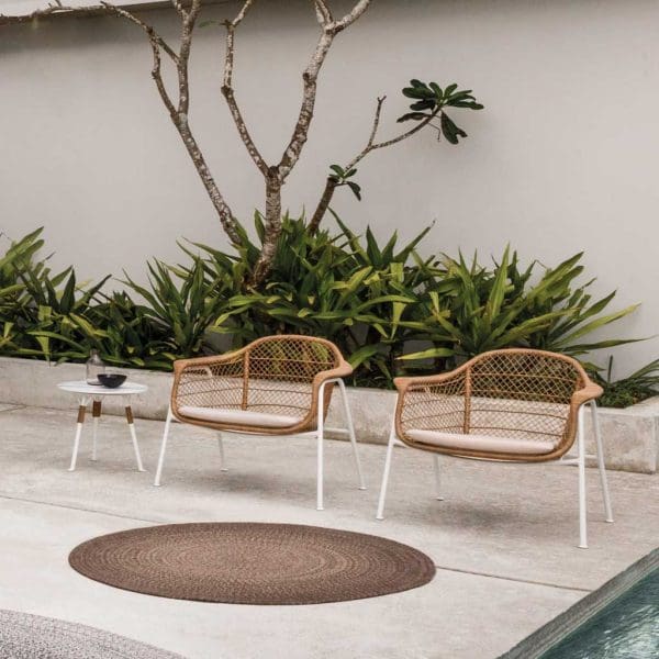 Image of Gloster modern wicker and aluminium garden chairs on poolside