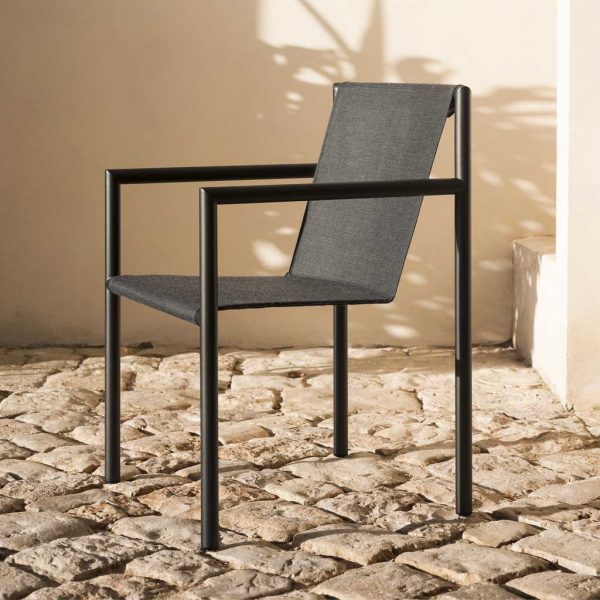 Image from side of Plein Air garden armchair by RODA, showing the furniture's tubular frame and slim Batyline fabric seat and back