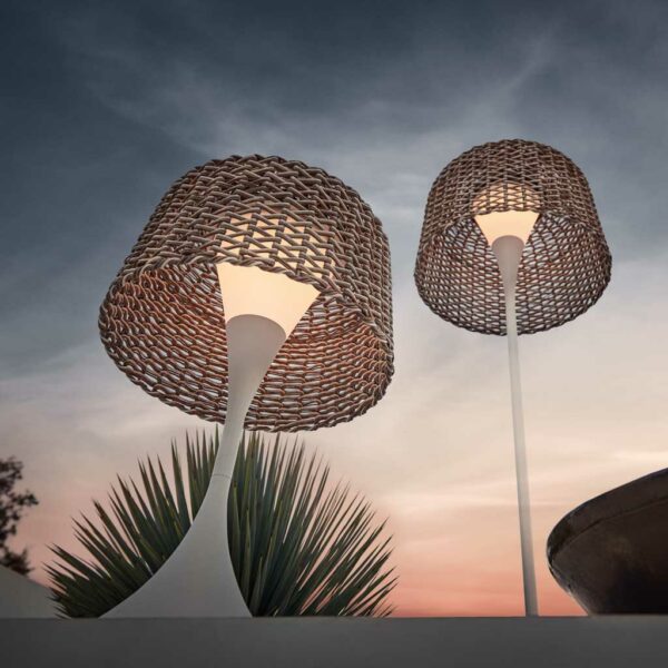 Image looking up the sculptural stem of Ambient Mesh modern outdoor lamps against the sky at dusk