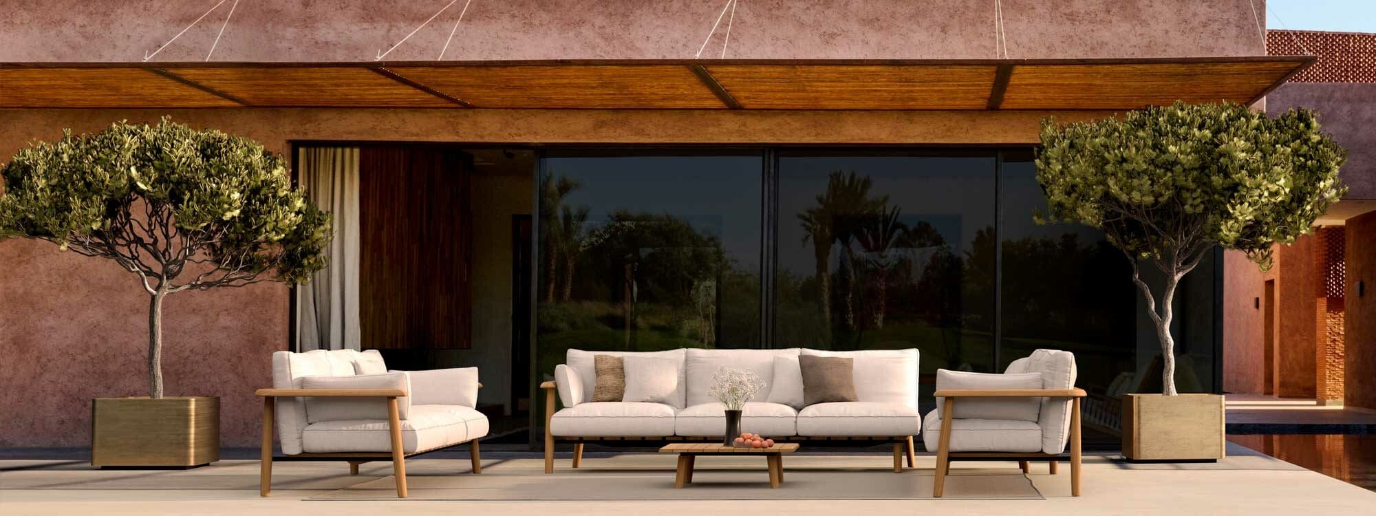 Image of Mambo teak garden sofa with Cuprum large circular brass planters either side, shown on terrace