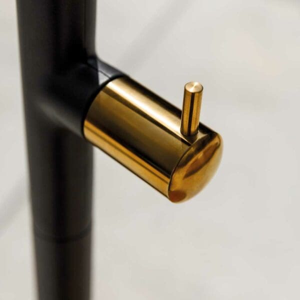 Image of detail of the polished brass-effect stainless steel tap fitted to Gloster modern outdoor shower