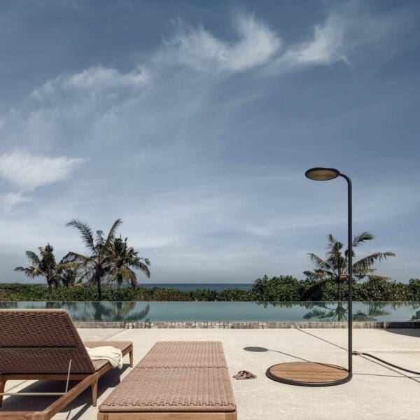 Image of Gloster contemporary outdoor shower on sunny poolside with blue sea and sky in the background