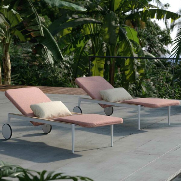 Image of pair of Royal Botania Styletto contemporary sun loungers on terrace, with banana and palm trees in the background