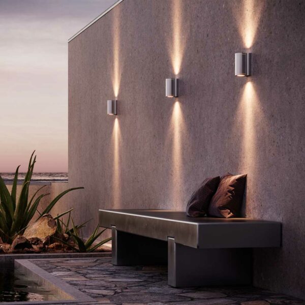 Image of Royal Botania Omega stainless steel up down wall lights at dusk