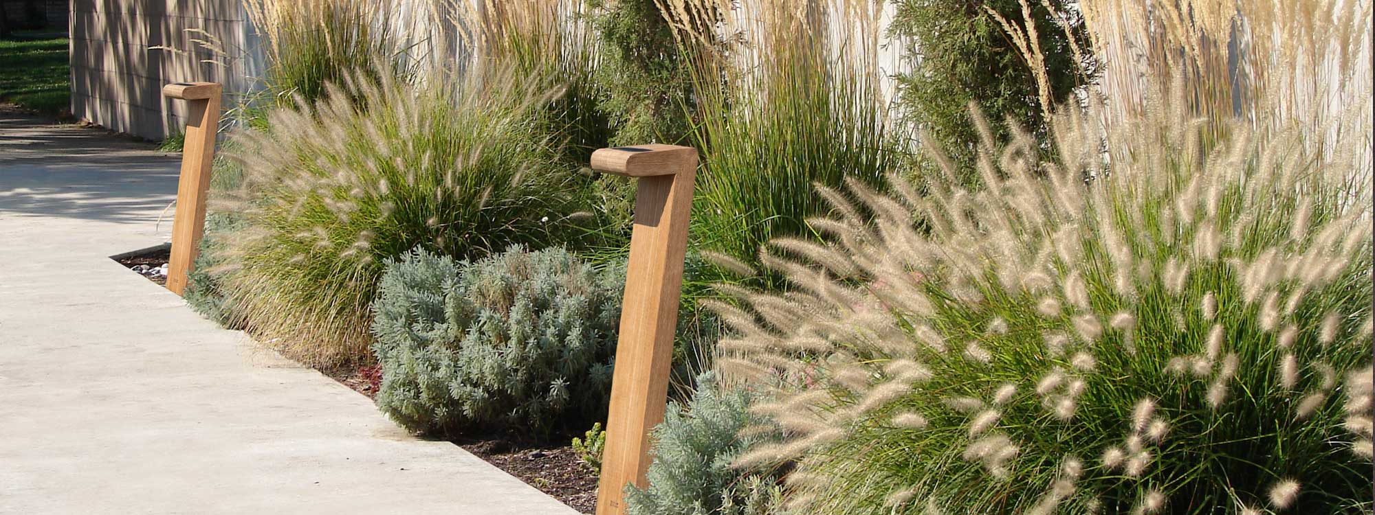 Image of Septem teak post light by Royal Botania, with grasses to the side and in the background
