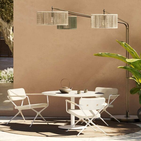 Image of Luniz garden floor light above Butler round table and Exes garden chairs by Royal Botania