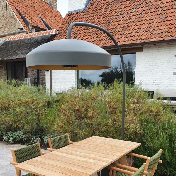Image of Heatsail Disc modern patio heater placed over teak garden dining furniture
