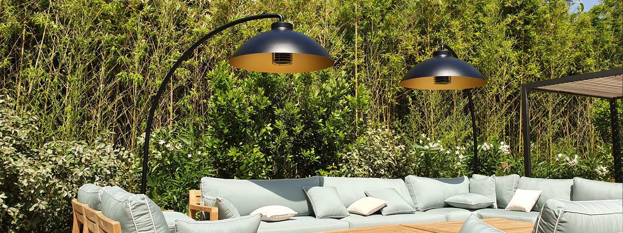 Image of pair of Dome electric patio heaters by Heatsail over large teak garden sofa on a sunny patio