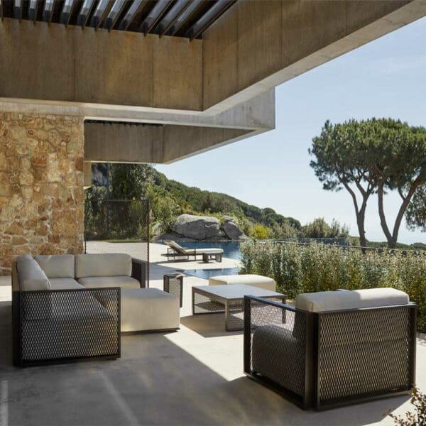 Image of Vondom The Factory modern outdo lounge furniture on terrace beneath a cantilevered ceiling