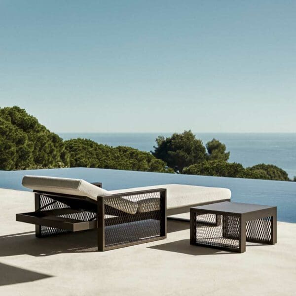 Image of The Factory adjustable sun lounger and side table by Vondom on sunny poolside terrace