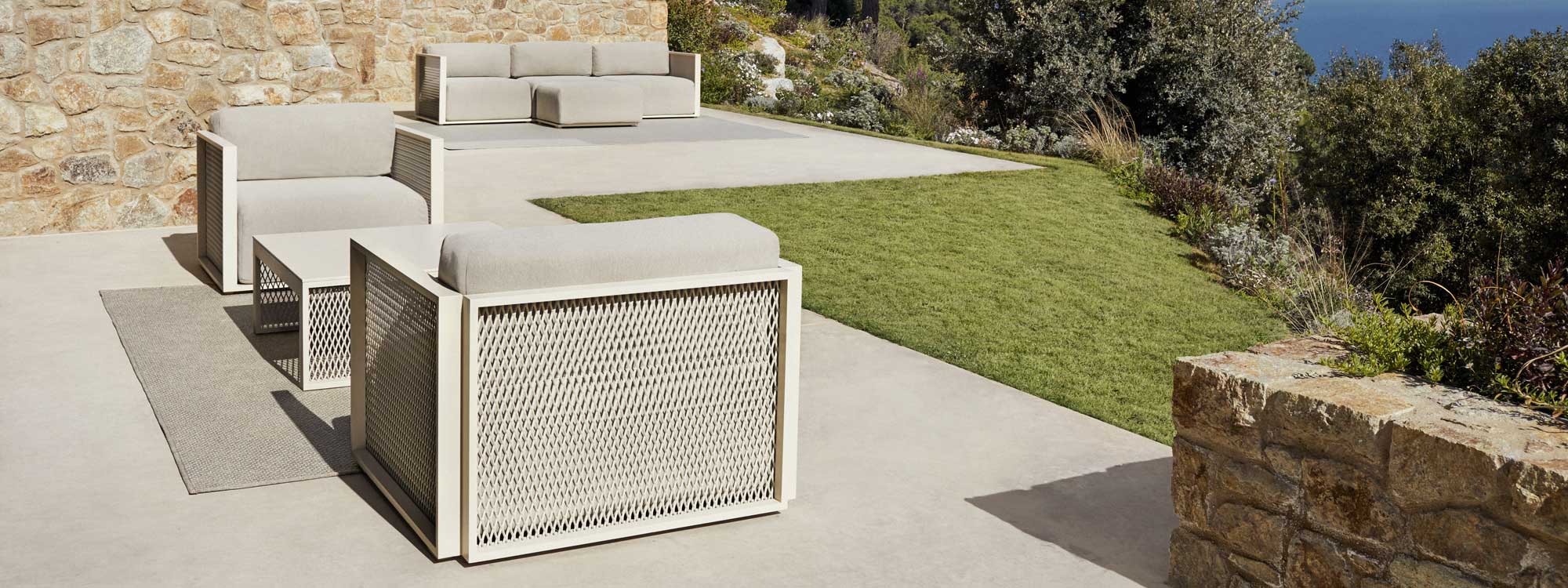 Image of Vondom The Factory white garden sofa and louge chair on sunny Spanish terrace