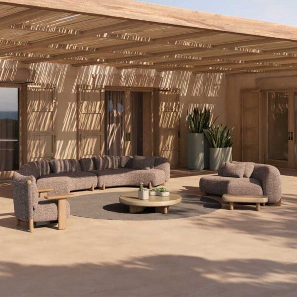 Image of Vondom Milos round garden sofa around a circular carpet in sunny courtyard